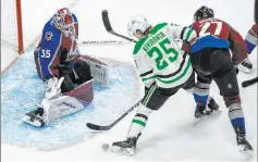  ?? Jason Franson The Associated Press ?? Stars left wing Joel Kiviranta, pressured by Avalanche defenseman Ryan Graves, moves in on Avs goaltender Michael Hutchinson in the third period of Dallas’ 5-4 overtime win Friday at Rogers Place.