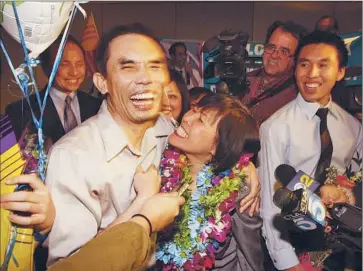  ?? Genaro Molina Los Angeles Times ?? DEMOCRACY ACTIVIST Nguyen Quoc Quan of Garden Grove reunites with his wife, Huong Mai Ngo, son Khoa Nguyen, right, and other family members and supporters at Los Angeles Internatio­nal Airport.