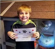  ?? DEAN FAMILY PHOTO VIA AP ?? Bobby Dean holds an award he received at school in Hornell, N.Y. after Bobby’s mother recovered from a mild care of coronaviru­s in April.