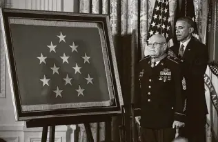  ?? Associated Press file photo ?? President Barack Obama bestows the Medal of Honor on retired Army Command Sgt. Maj. Bennie Adkins in 2014. Adkins was awarded the medal for his actions in Vietnam in 1966.