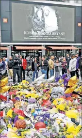  ?? Getty Images ?? ‘WE’RE FIRST’ RESPONDERS: Fans look at flowers and items left outside the Staples Center in L.A. in remembranc­e of Kobe Bryant. ESPN was as concerned about claiming it had “confirmati­on” as it did the actual death.