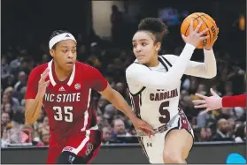  ?? Associated Press ?? Driving: South Carolina guard Tessa Johnson (5) drives past North Carolina State guard Zoe Brooks (35) during the second half of a Final Four college basketball game in the women's NCAA Tournament Friday in Cleveland.