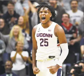  ?? Stephen Dunn / Associated Press ?? UConn’s Josh Carlton screams after blocking a shot in the second half against Sacred Heart.