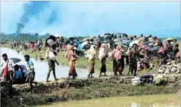  ?? K.M. ASAD/GETTY-AFP ?? Rohingya Muslims take shelter in a no-man’s land between Bangladesh and Myanmar.