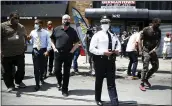  ?? MATT ROURKE — THE ASSOCIATED PRESS ?? Philadelph­ia Police Commission­er Danielle Outlaw, center, and Mayor Jim Kenney, 4th left, meet with people, Thursday in Philadelph­ia.