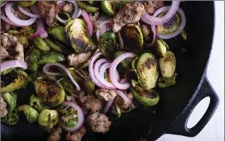  ?? KARSTEN MORAN, NYT ?? Sautéed brussels sprouts with sausage and pickled red onion.