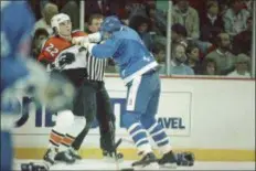  ?? THE ASSOCIATED PRESS FILE ?? Then-Flyers star tough guy Rick Tocchet, left, takes a fist from Quebec’s Greg Smyth during a first period fight on Oct. 21, 1988 at the Spectrum. The Flyers are one of only two teams in the NHL without a fight a quarter of the way through the 2018-19 season. Tocchet is the head coach of the Arizona Coyotes, the only other team without a fighting major this season.