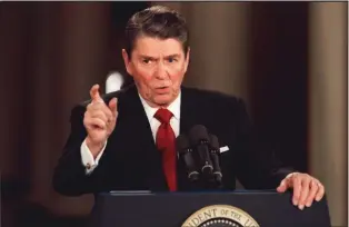  ?? DENNIS COOK, FILE — THE ASSOCIATED PRESS ?? President Ronald Reagan seen here in 1987 during a news conference at the White House, used the slogan “It’s morning in America” to set an effective theme for his presidency.