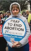  ?? Eli Hartman/Contributo­r ?? Abortion opponents pray after the Texas Rally for Life march Saturday that drew thousands to Austin.