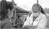  ?? FEDERICA NARANCIO/ASSOCIATED PRESS ?? A health “promotora” (health promoter) from CASA, tries to enroll Latinos as volunteers to test a potential COVID-19 vaccine at a farmers market in Takoma Park, Maryland.