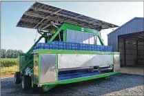  ?? PHOTO COURTESY OF LUCILLE LANNIGAN ?? The Harvy500 is a new machine that revolution­izes the way farmers harvest blueberrie­s. Its “shakers” rattle blueberrie­s off the bush and brushes collect them at the bottom. With solar panels, the harvester can run all day by itself.