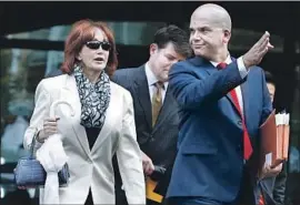  ?? Jacquelyn Martin Associated Press ?? KATHLEEN MANAFORT, leaving court with defense lawyer Jay Nanavati on Tuesday, sat behind her husband in the courtroom as the verdicts were read.