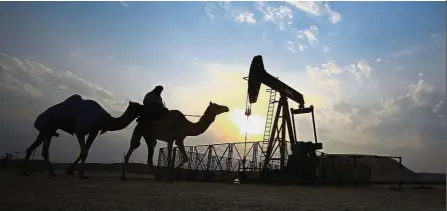  ??  ?? No decision: A file picture showing a man on a camel riding through the desert oil field of Sakhir, Bahrain. A recent gathering between Opec and its allies ended with no decision on an extension or deepening of the cuts beyond the first quarter of...