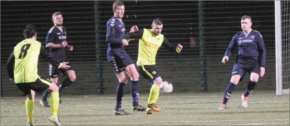  ??  ?? The Ardee Celtic defenc e try to keep tabs on former Dundalk and Drogheda United striker Tiarnan Mulvenna.