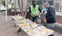  ??  ?? Eric Ngema and Anivesh Singh setting up a book sale at St Anne’s Church, Sydenham.