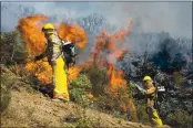  ?? FILE- LAKE COUNTY PUBLISHING ?? Jared Hendricks (right) and Mark Switzer light standing brush on fire to clear a hillside of vegetation at risk of spreading wildfires.