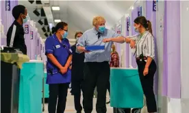  ?? Photograph: Alberto Pezzali/AFP/Getty Images ?? ‘I think we’re allowed to shake hands these days, what?!’ ‘No thanks.’ Boris Johnson visits a Covid-19 vaccinatio­n centre in north London.