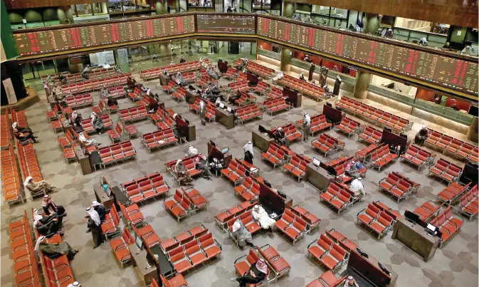  ??  ?? KUWAIT CITY: Kuwaiti traders follow the stock market at the Kuwait Stock Exchange (KSE) in Kuwait City yesterday, the first working day of the New Year. — Photo by Yasser Al-Zayyat