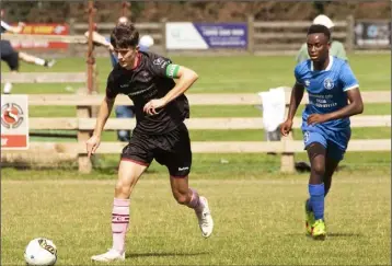  ??  ?? Darragh Levingston of Wexford F.C. U-17s is chased by Tony Mambuma of Limerick.