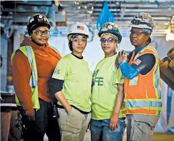  ?? BEBETO MATTHEWS/AP ?? From left, Tameeka Gwyn, a plumber; carpenter Nora Vega; Janna Rojas, an apprentice plumber; and Myrtle Wilson, a journeyman laborer, pose at a work site of a new high-rise for the Memorial Sloan Kettering Cancer Center in New York.