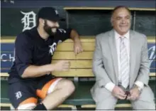  ?? CARLOS OSORIO — THE ASSOCIATED PRESS ?? Tigers catcher Alex Avila, left, shares a laugh with his father, general manager Al Avila during an interview in dugout in Detroit. the