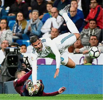  ?? — AFP ?? Up and away: Eibar’s Arbilla sends Real Madrid’s Theo Hernandez airborne during the La Liga match at the Bernabeu on Sunday.