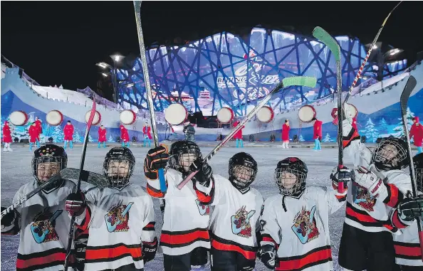  ?? — GETTY IMAGES FILES ?? Young hockey players perform during a New Year’s Eve countdown event to promote the city’s 2022 Winter Olympic bid at Olympic Park on December 31, 2014, in Beijing, China.