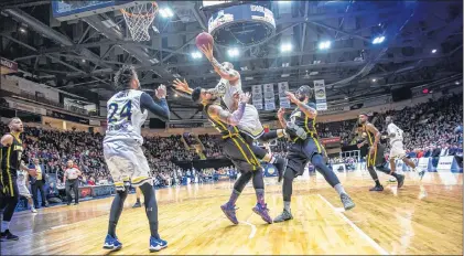  ?? ST. JOHN’S EDGE PHOTO/JEFF PARSONS ?? St. John’s Edge centre Grandy Glaze goes to the basket against Julian Boyd of the London Lightning during Game 3 of their National Basketball League of Canada division final Saturday night at Mile One Centre, as players from both teams, including...