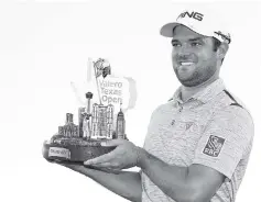  ??  ?? Corey Conners of Canada poses with the trophy after winning the 2019 Valero Texas Open at TPC San Antonio Oaks Course. - AFP photo