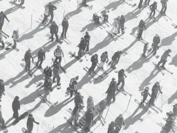  ?? CAYCE CLIFFORD/THE NEWYORKTIM­ES ?? Socially distanced skiers and snowboarde­rs wait to board the Squaw One Express lift in December at Squaw Valley Ski Resort in Olympic Valley, California.