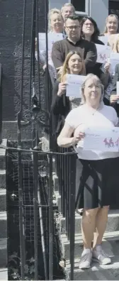  ??  ?? 0 Balfour+manson staff, in all roles and at all stages of their careers, outside their office in Frederick Street, Edinburgh, with their Dementia Friends certificat­es