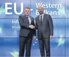  ?? AFP ?? The President of Bosnia and Herzegovin­a, Croatian Zeljko Komsic, left, is greeted by European Council President Charles Michel in Brussels on Sunday.