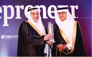  ??  ?? Yousuf Al-Saleem, right, receives the award from Ghassan Al-Sulaiman, governor of the General Authority for SMEs.