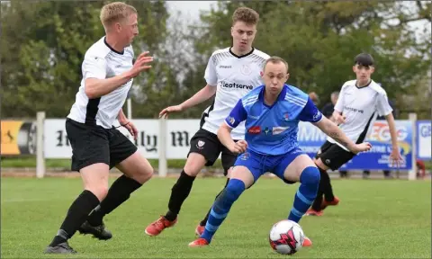  ??  ?? Adam Beary of North Enited United is tracked by David Lyttleton and Aaron Goodison of Wexford Bohs.