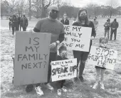  ?? DON STACOM/HARTFORD COURANT ?? Jeff and Sarah Hong of Glastonbur­y brought their children Quinn, left, and Reilly to Saturday’s rally in Hartford against violence toward Asian-Americans and Pacific Islanders. “I want to make sure my children understand their voice matters,”Jeff Hong said.