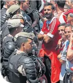  ??  ?? Police guard River Plate supporters