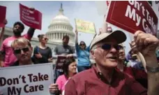  ?? ALEX WONG/GETTY IMAGES ?? Activists march at a Stop Trumpcare rally in Washington. Congressio­nal Democrats joined the rally to oppose the Republican­s’ health-care bill.