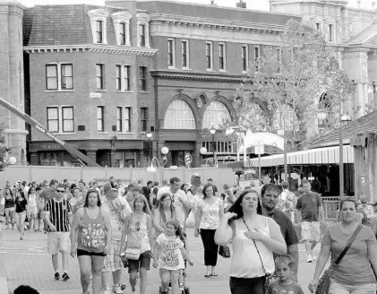  ?? JOE BURBANK/STAFF FILE PHOTO ?? Guests walk past the entrance to The Wizarding World of Harry Potter — Diagon Alley, at Universal Studios Florida in Orlando during its constructi­on in 2014. Universal’s theme park division generated $1.3 billion in the first quarter of 2018, the...