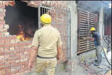  ?? HT PHOTO ?? Firemen outside the house that was burnt in Karnal town on Thursday.