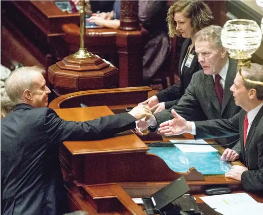  ?? SUN-TIMES FILE PHOTO ?? Gov. Bruce Rauner (left) reaches out to shake hands with House Speaker Michael Madigan, D-Chicago, after delivering his budget address to a joint session of the General Assembly on Feb. 14, 2018, at the Capitol in Springfiel­d.