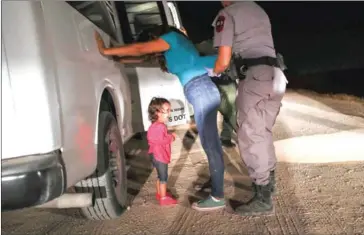  ?? JOHN MOORE/GETTY IMAGES NORTH AMERICA/AFP ?? A two-year-old Honduran asylum seeker cries as her mother is searched and detained near the US-Mexico border in McAllen, Texas, on June 11.