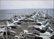  ?? U.S. NAVY VIA AP ?? Sailors work on the flight deck of the aircraft carrier USS Abraham Lincoln in the Arabian Sea on Sunday. The U.S. deployed the carrier and bombers to the region over threats from Iran.