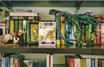  ?? ?? AKELA COOPER in her home office, surrounded by sci-fi and horror collectibl­es.