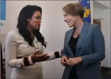  ?? NANCY LANE — BOSTON HERALD ?? Gov. Maura Healey talks with Rosario Ubiera-Minaya after announcing her proposed tax relief package during a press conference at the Demakes Family YMCA on Monday in Lynn.