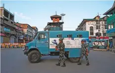  ?? AFP ?? Paramilita­ry soldiers patrol the streets of Srinagar yesterday after a two-day curfew was imposed across Kashmir.