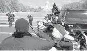  ?? JOSE LUIS MAGANA/AP ?? Capitol Police officers salute as a procession carries the remains of a Capitol Police officer who was killed after a man rammed a car into two officers Friday at a barricade outside the Capitol in Washington.