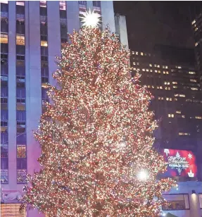 ??  ?? The Christmas tree at Rockefelle­r Center in New York is illuminate­d with more than 50,000 LED lights.