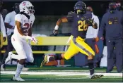  ?? THEARON W. HENDERSON — GETTY IMAGES ?? California’s Damien Moore (28) carries the ball for a 54yard gain while pursued by Stanford’s Kendall Williamson (21) during the third quarter Friday at California Memorial Stadium in Berkeley.