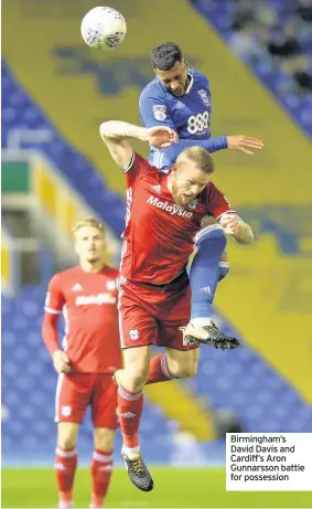  ??  ?? Birmingham’s David Davis and Cardiff’s Aron Gunnarsson battle for possession