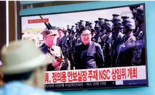  ?? THE ASSOCIATED PRESS ?? A TV screen shows a local news program reporting on North Korea's missiles with an image of North Korea's leader Kim Jong Un at the Seoul Train Station in Seoul, South Korea, on Saturday. North Korea fired a missile over Japan Tuesday.